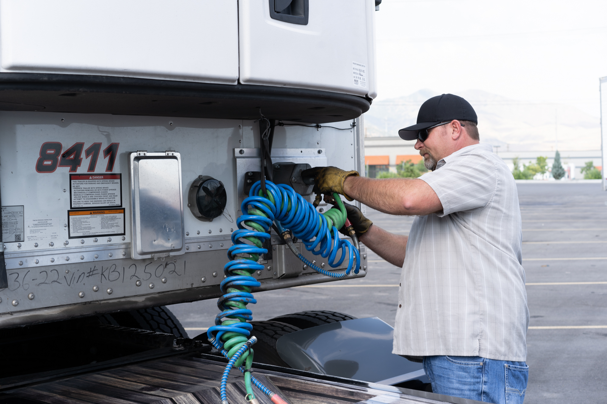 pride transport employee working on truck
