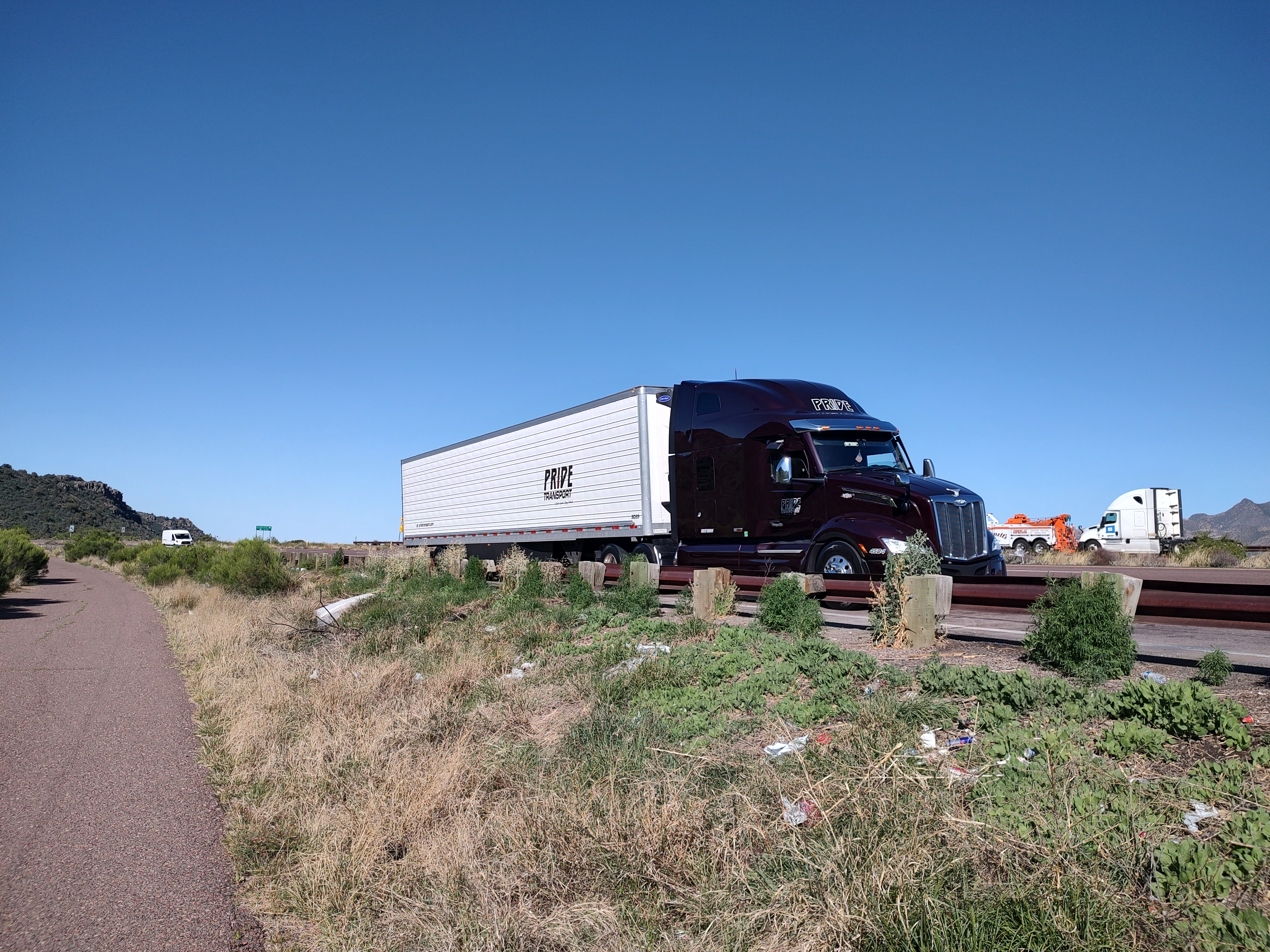maroon pride transport truck parked on shoulder