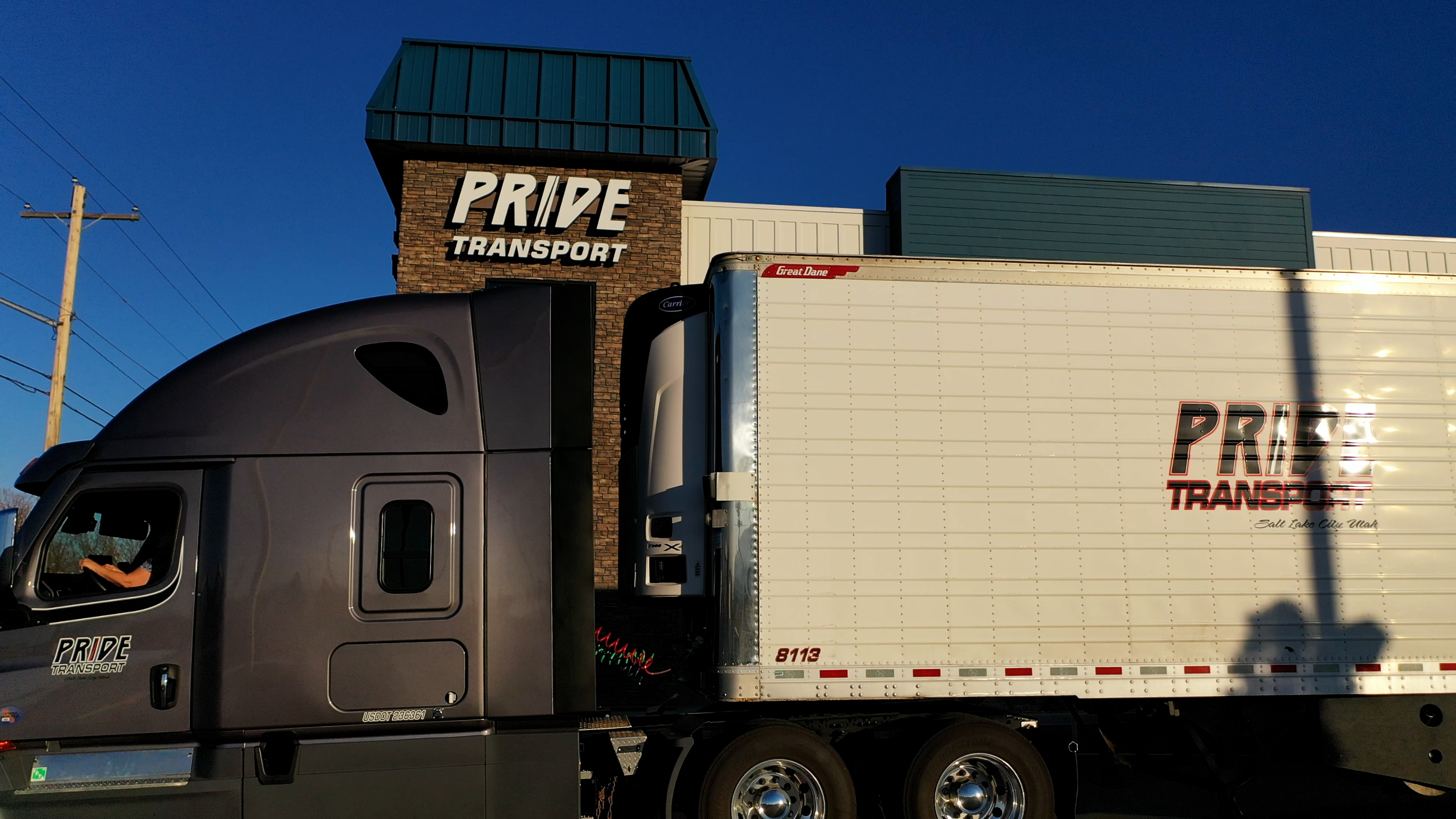 semi truck in front of pride transport headquarters