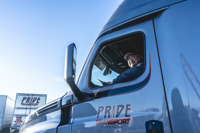 pride transport driver smiling from inside truck