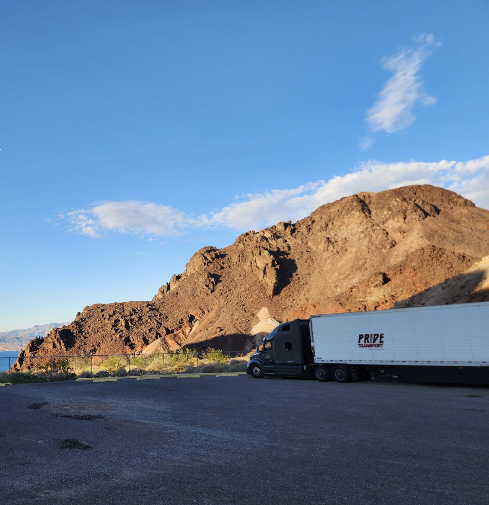 pride transport truck with red rock mountainscape in background