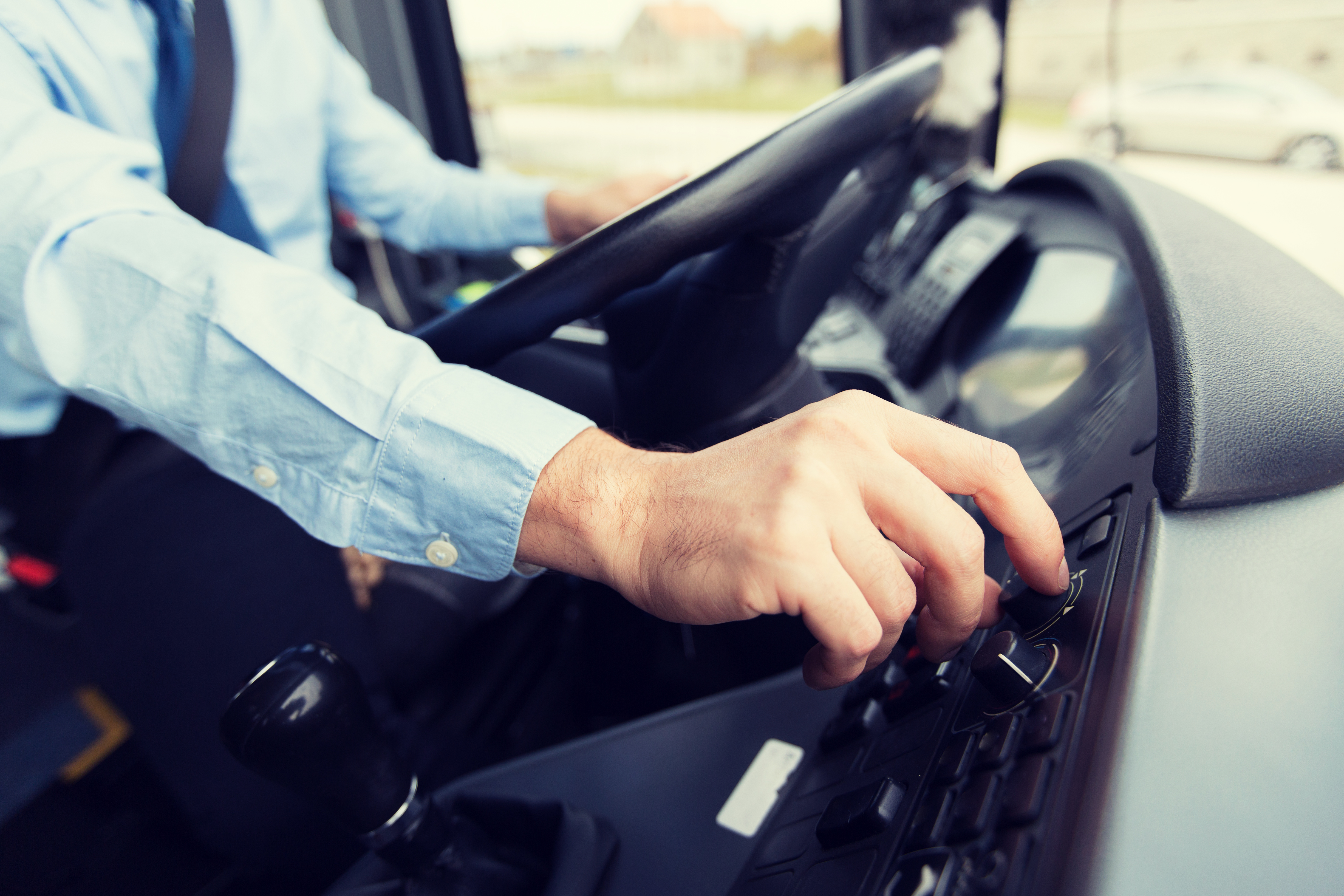 bus driver with their hands on the steering wheel