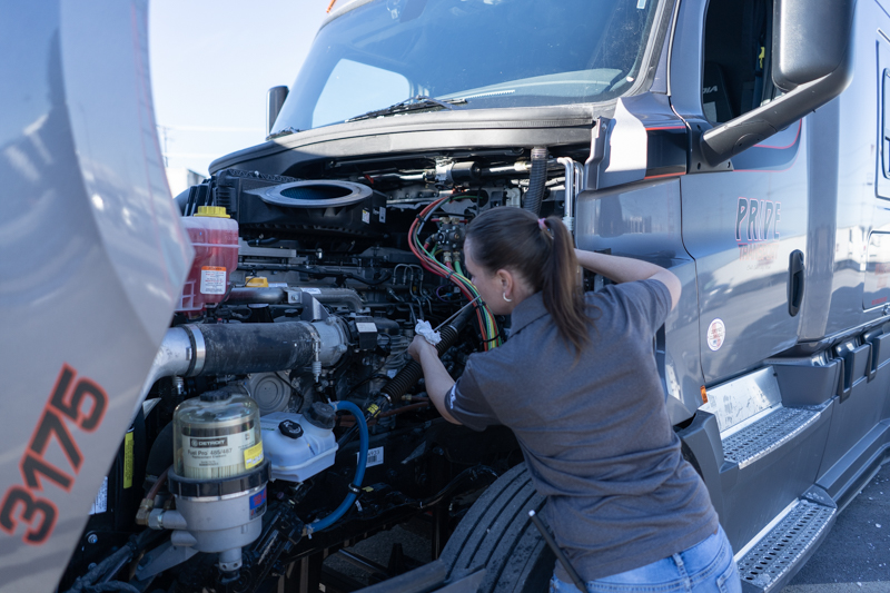 pride transport employee checking engine