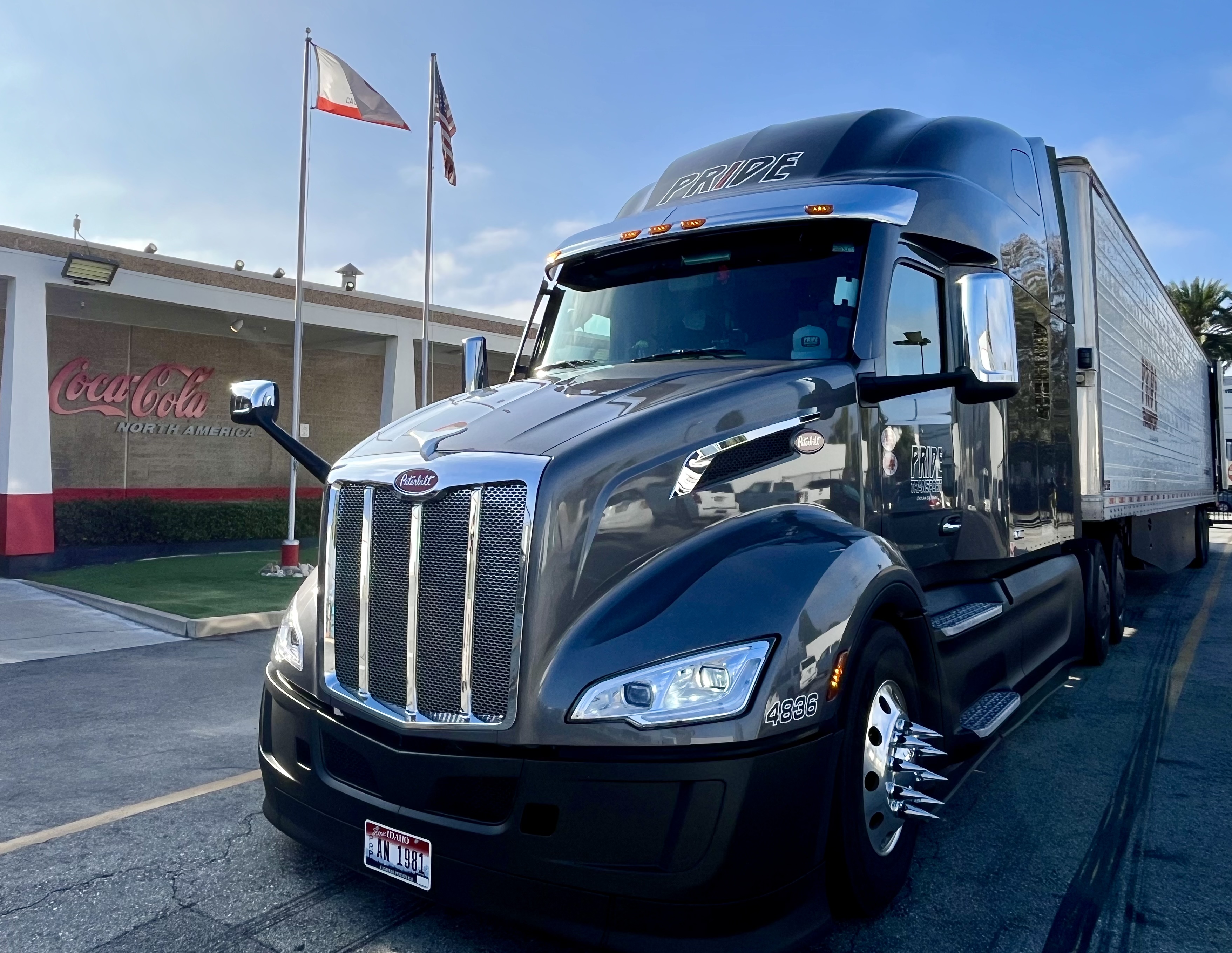 pride transport truck in front of cocacola building