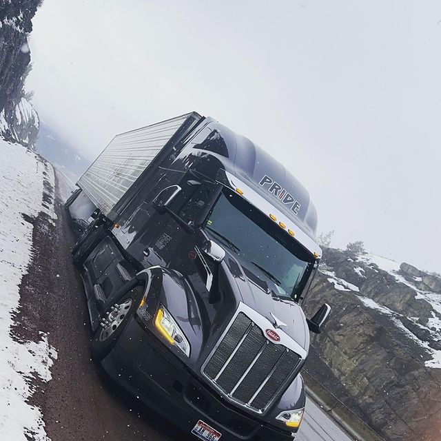 pride transport truck in winter landscape
