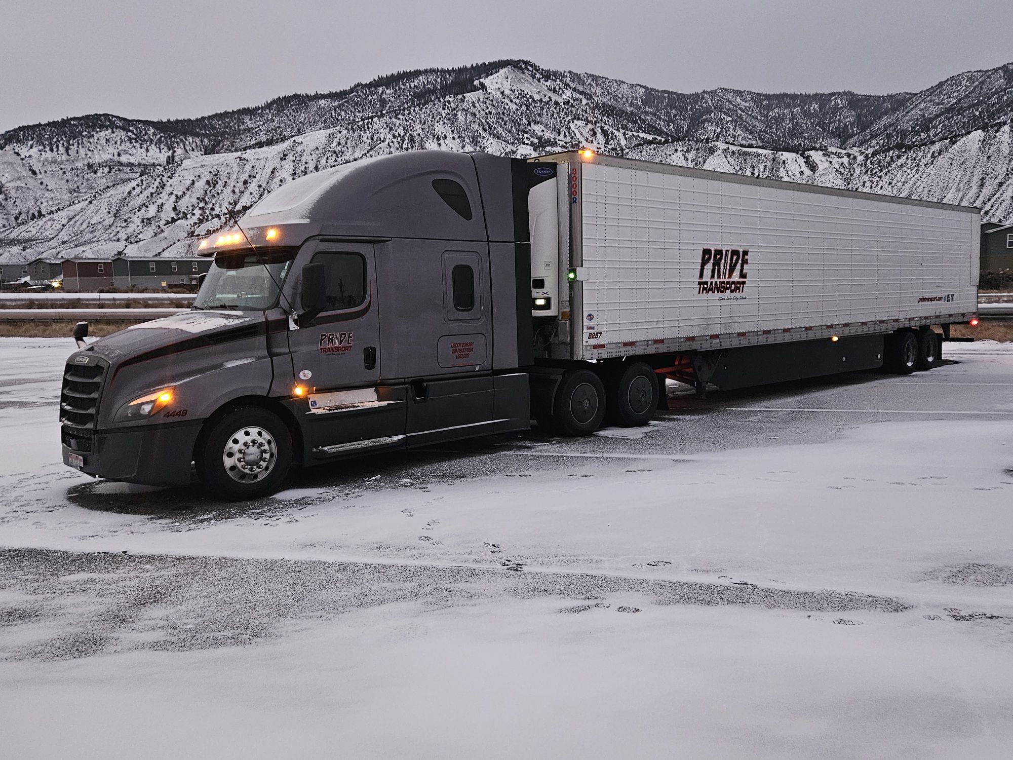 pride transport truck parked with snow in background