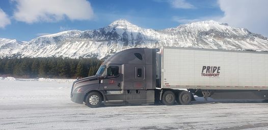 pride transport truck with snowy mountainscape in background