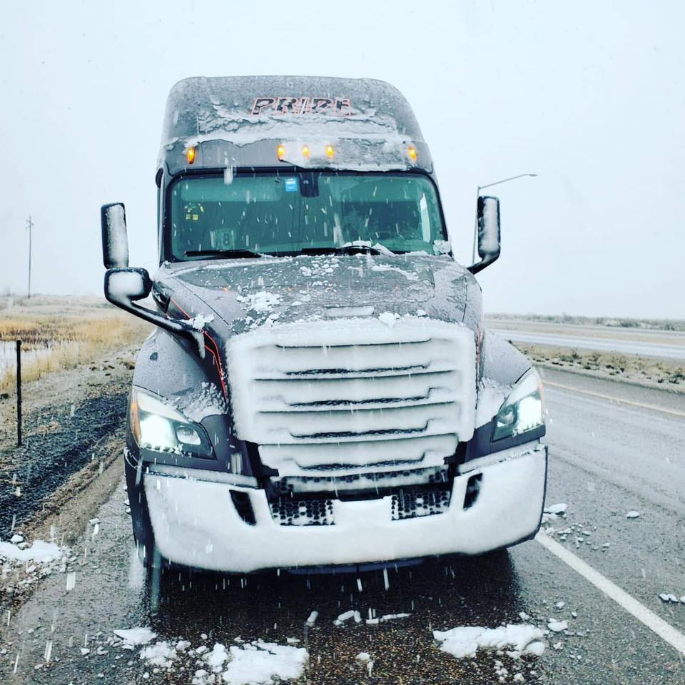 pride transport truck with ice on front grill