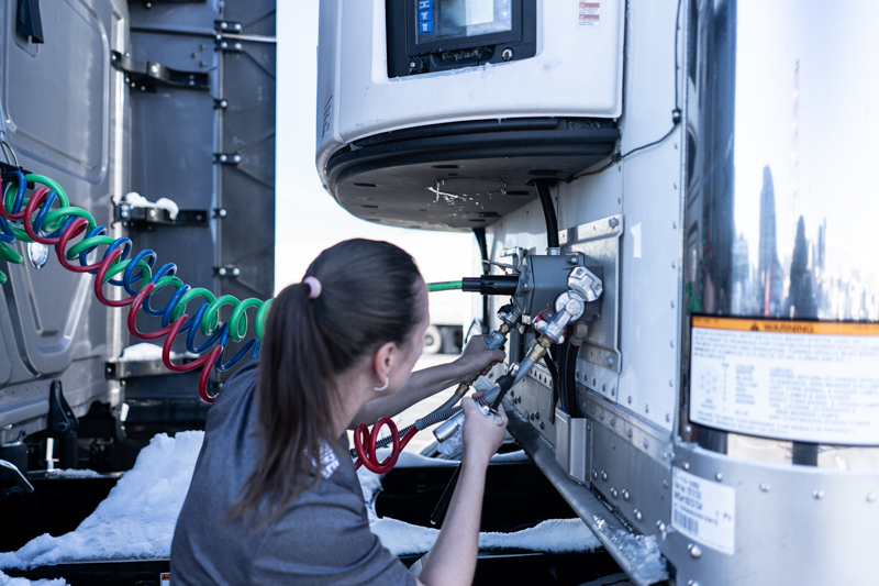 pride transport woman employee working on truck