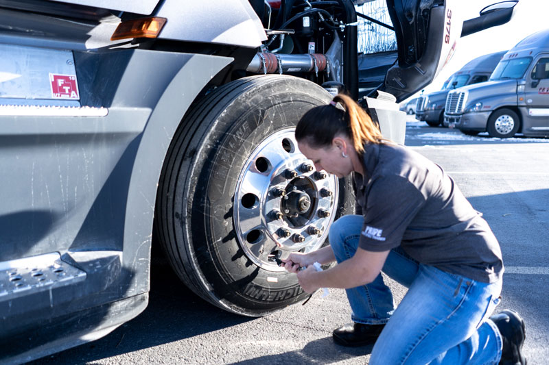 woman truck driver working on truck